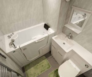 Completed bathroom renovation by Age Care Bathrooms featuring a walk-in bath with an integrated door, a white vanity washbasin unit with a concealed-cistern toilet, and modern grey wall panels.